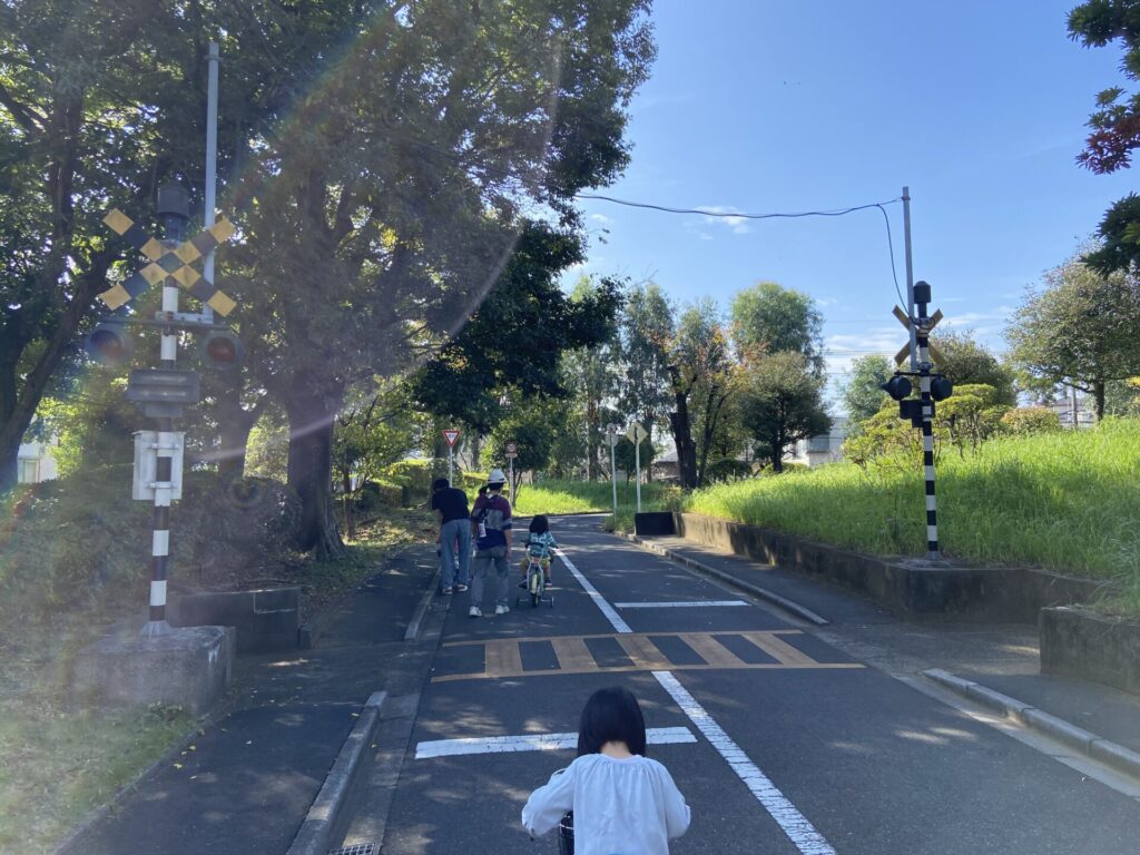 交通農園の踏切で自転車をこぐ子供